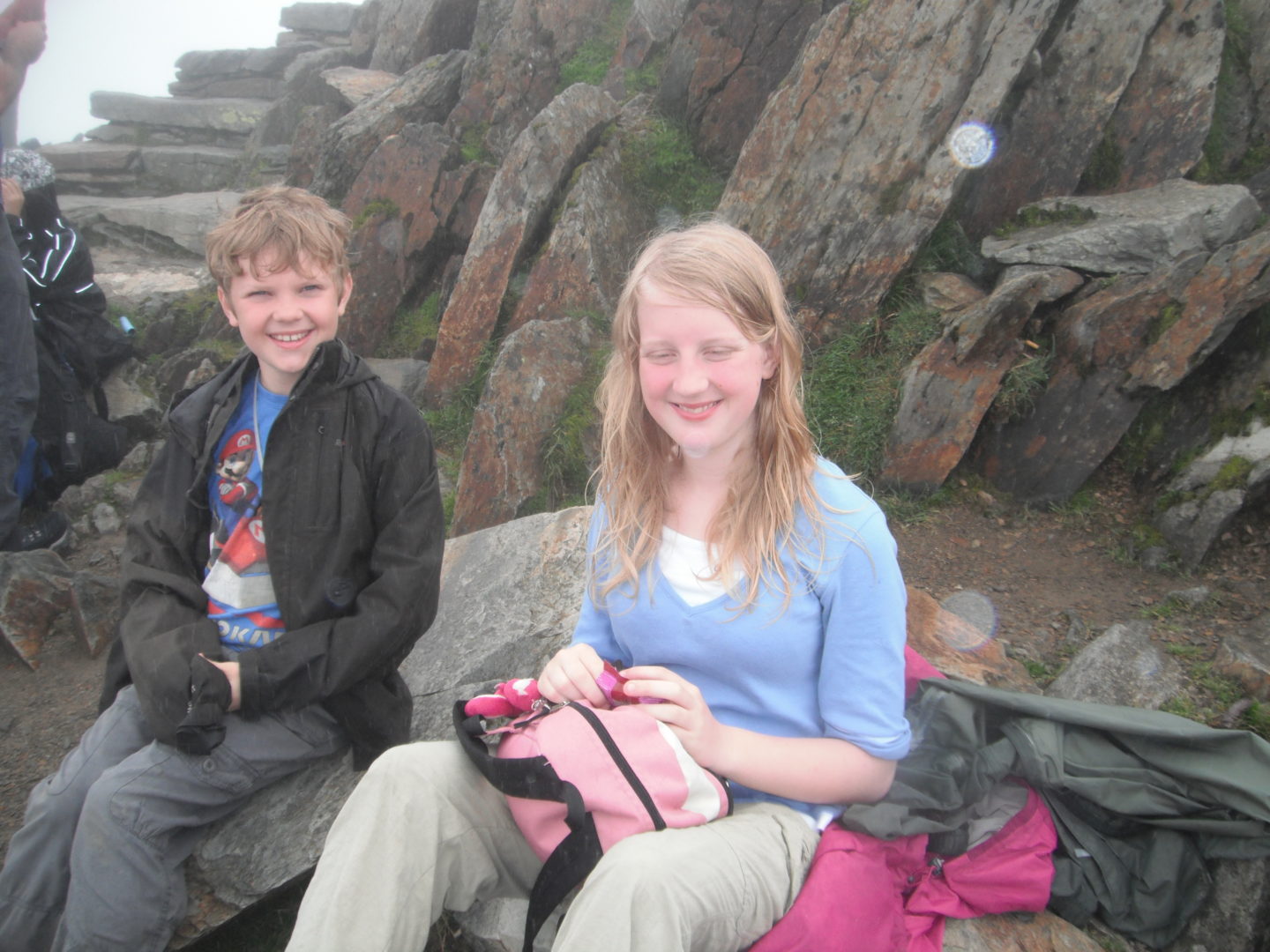 Xene and Lochlan eating lunch on the summit of Mount Snowdon