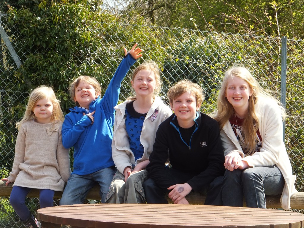 five children sitting on a bench at Africa Alive