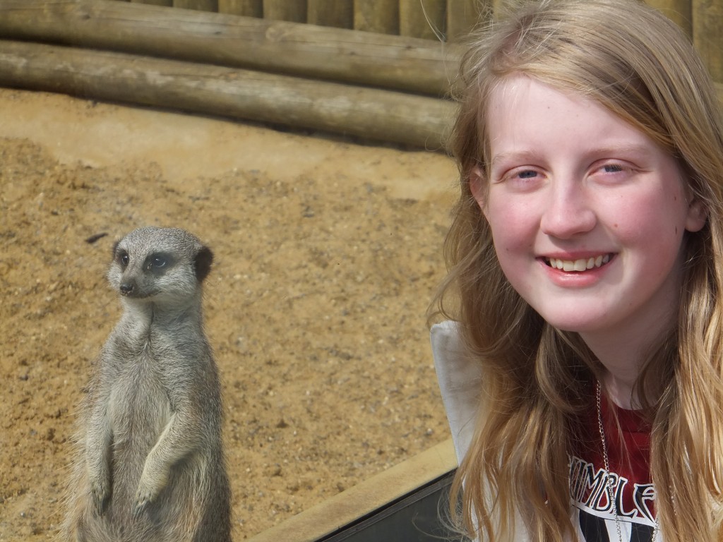 Xene standing next to a meerkat at Africa Alive