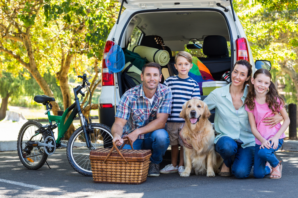 Happy family getting ready for road trip on a sunny day
