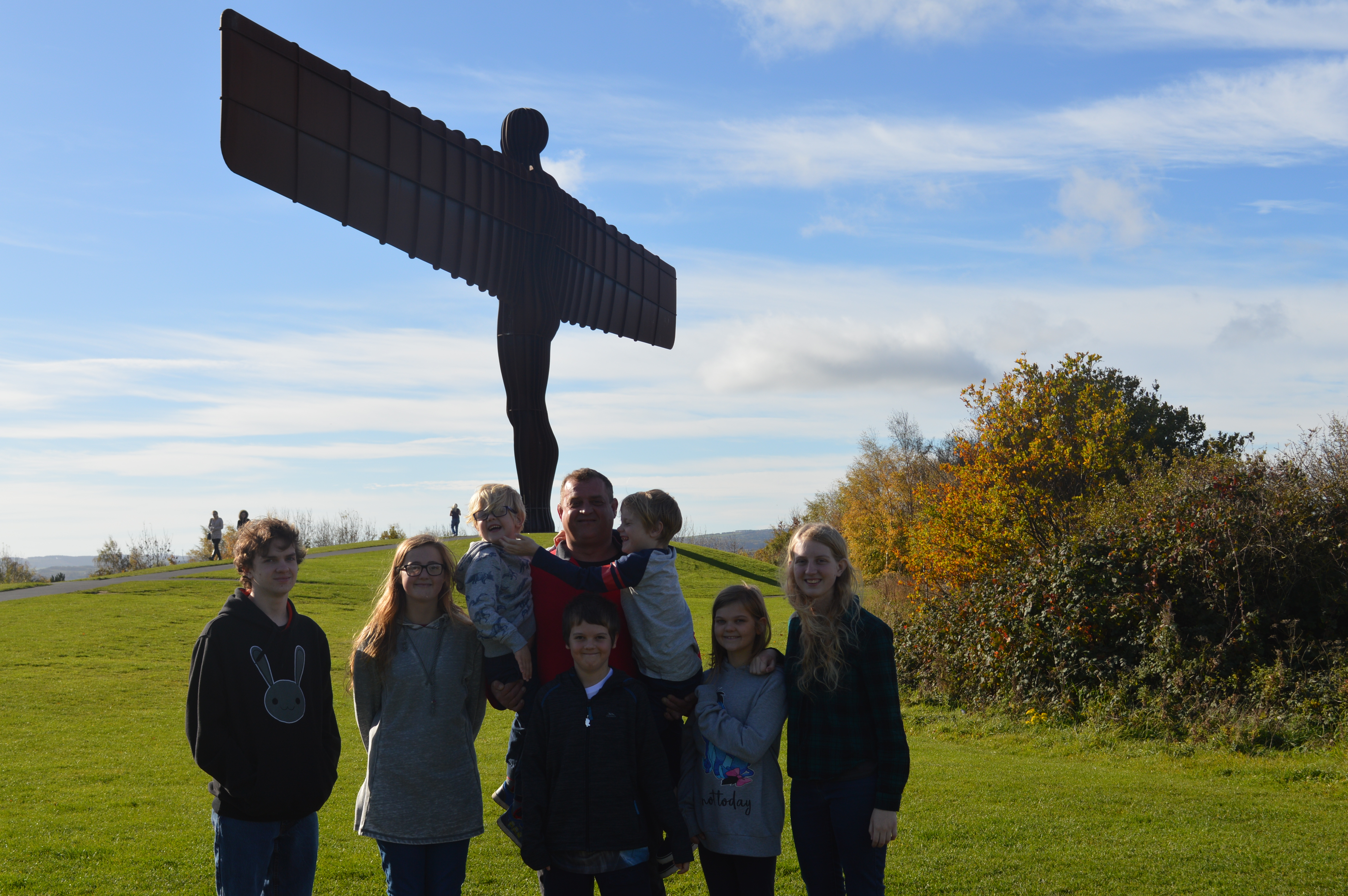 Family photo with angel of the north in the background on a A day trip to Newcastle