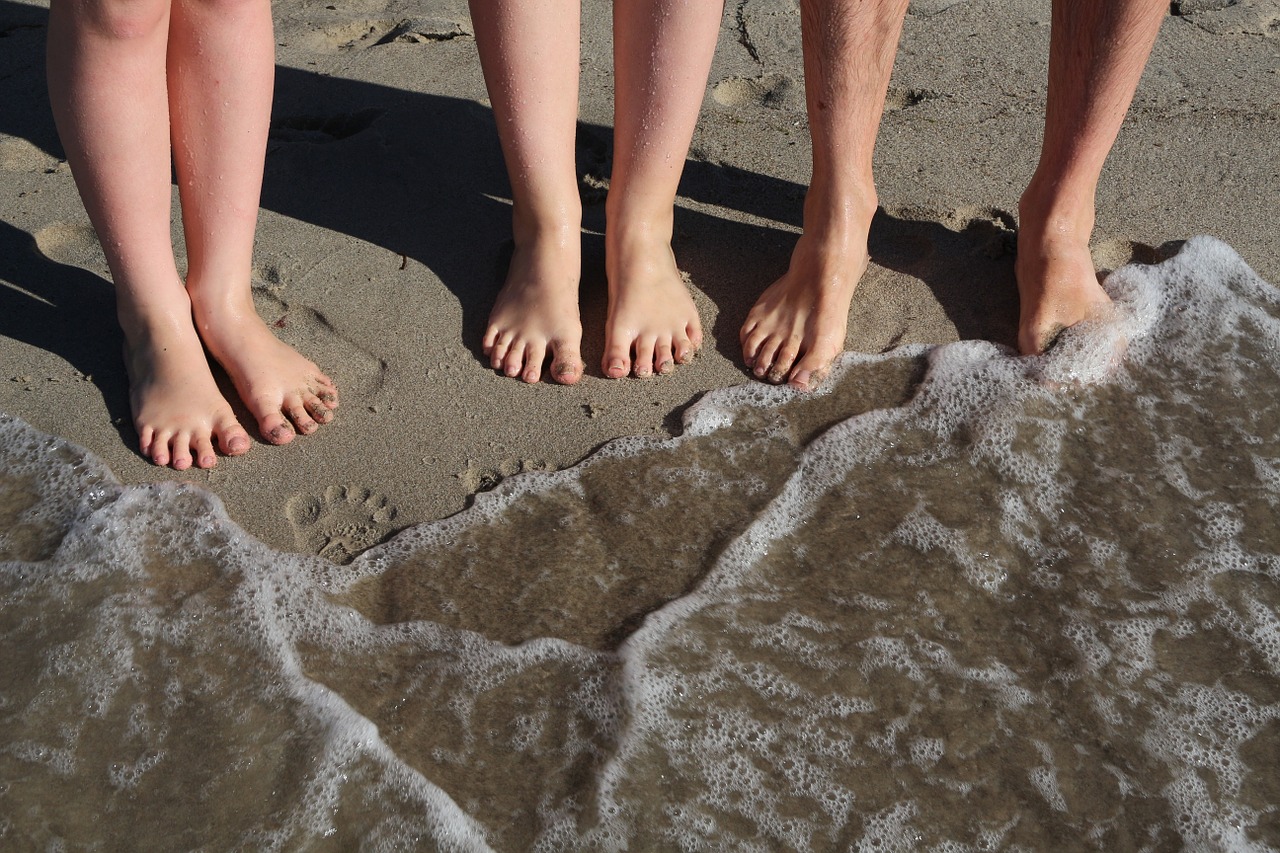 family travel paddling in the sea